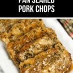 Pan Seared Pork Chops glisten with herbs atop a white plate, framed by a checkered cloth backdrop.