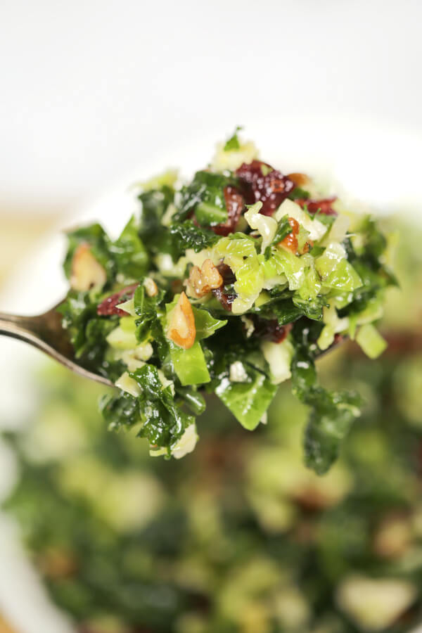 Kale Brussels Sprouts Salad on a metal fork.