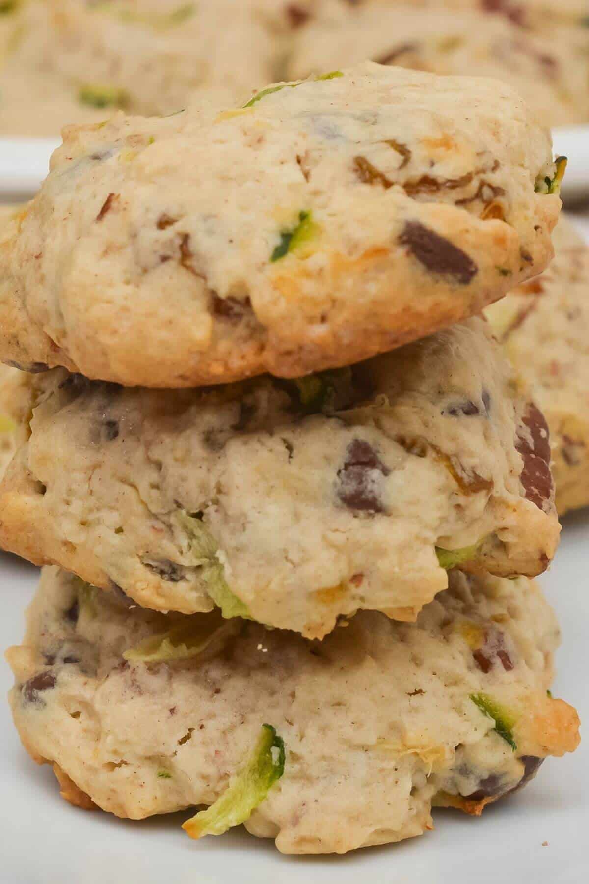 Three homemade treats are stacked on a white surface, with more blurred in the background.