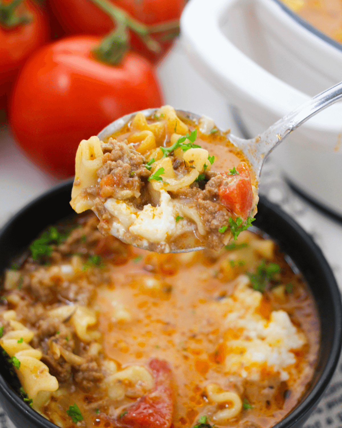 Savor a hearty bowl of One Pot Lasagna Soup brimming with meat and tomatoes.