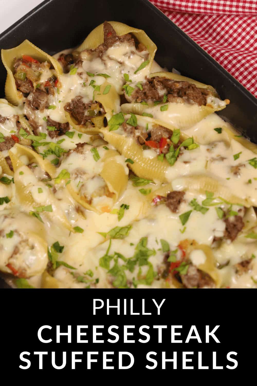 Philly Cheesesteak Stuffed Shells: Baked pasta shells filled with savory beef and peppers, topped with melted cheese and garnished with fresh chopped parsley.