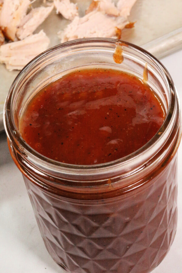 apple cider barbecue sauce in a mason jar.