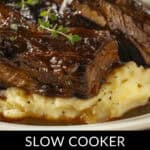 Close-up of tender slow-cooked beef short ribs enriched with beer and herbs, elegantly served atop creamy mashed potatoes. Text reads: "Slow Cooker Beef Short Ribs with Beer.