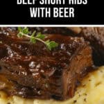 Close-up of slow cooker beef short ribs glazed with sauce, garnished with thyme, and served on a bed of mashed potatoes.