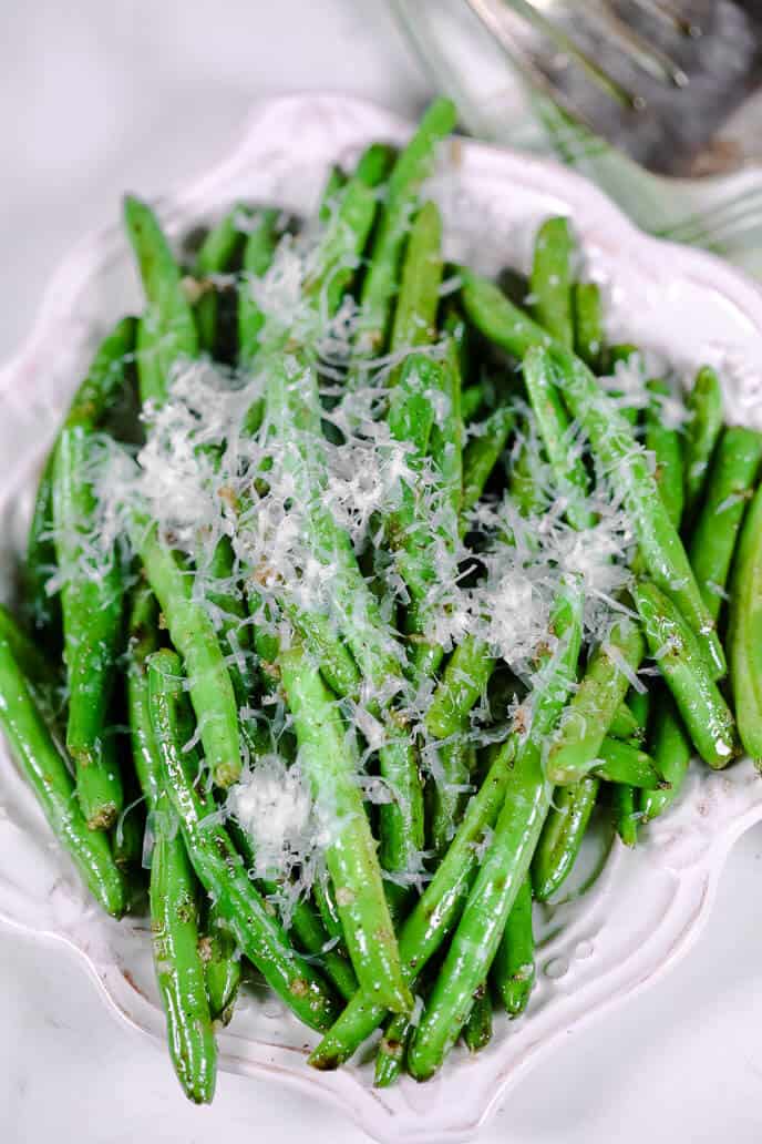 parmesan green beans on a white plate 