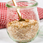 Steak rub in a jar with a gold spoon for making the best steak recipe