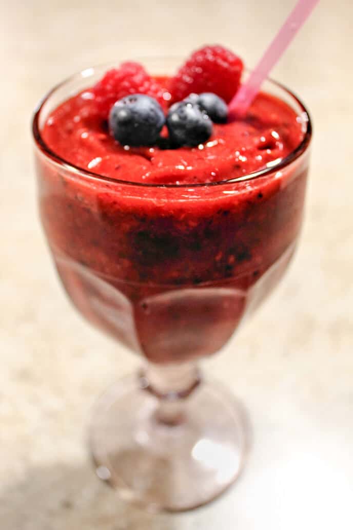 Easy Healthy Smoothie recipe with berries in a glass with pink straw
