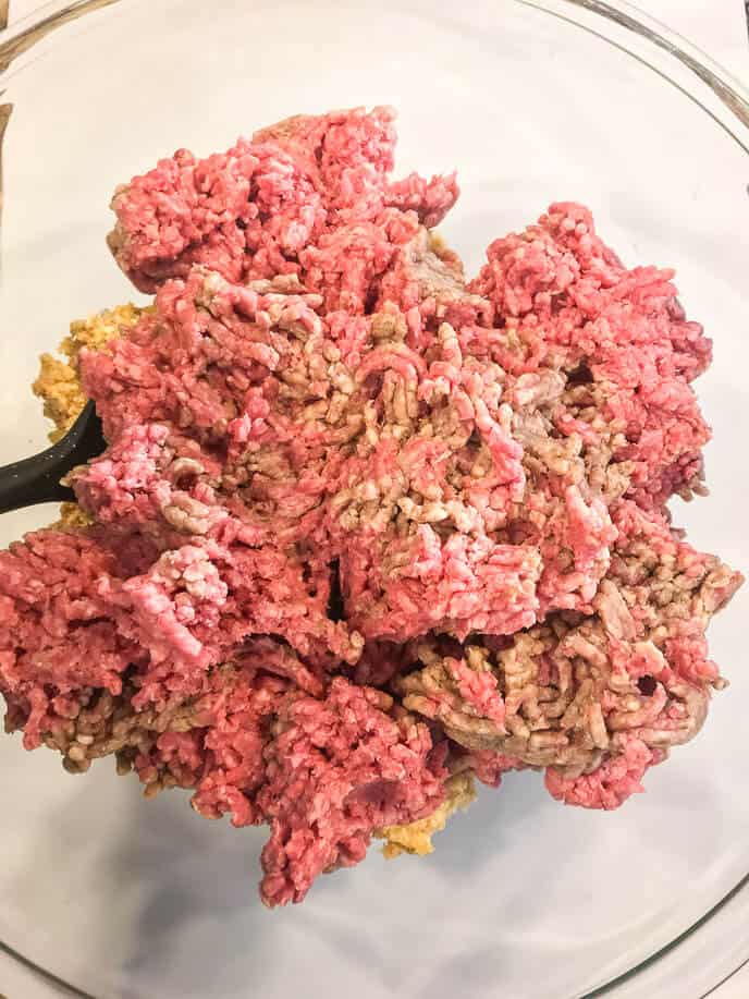 Ground Beef, on a white plate with a black spoon. 