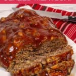 Instant Pot Meatloaf on a white platter with a red striped napkin