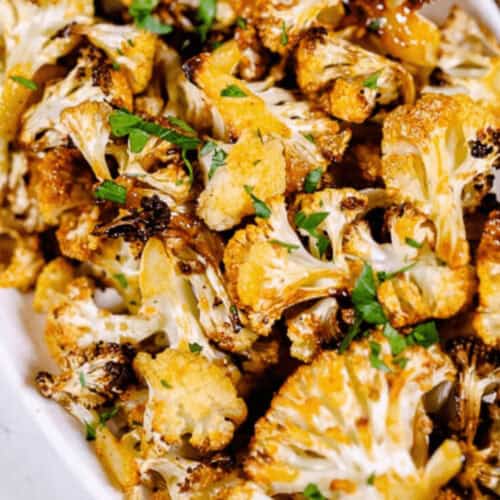 A white serving bowl of the roasted spicy cauliflower.