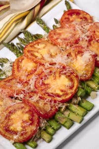 Easy asparagus recipe on a white platter with a striped napkin