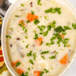 A creamy chicken soup with carrots and parsley.