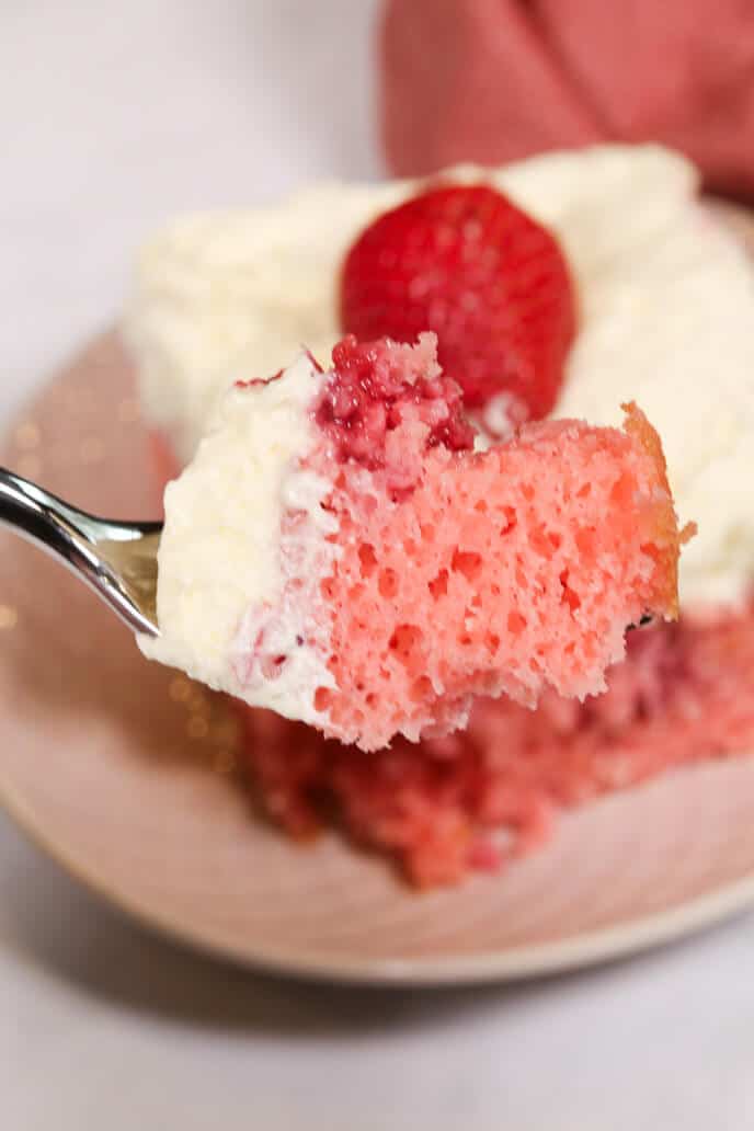 Fresh strawberry poke cake on a fork