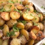 Roast Potatoes with Cheese and Parsley in white bowl
