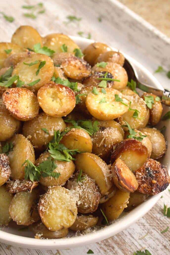 Roast Potatoes with Cheese and Parsley in white bowl