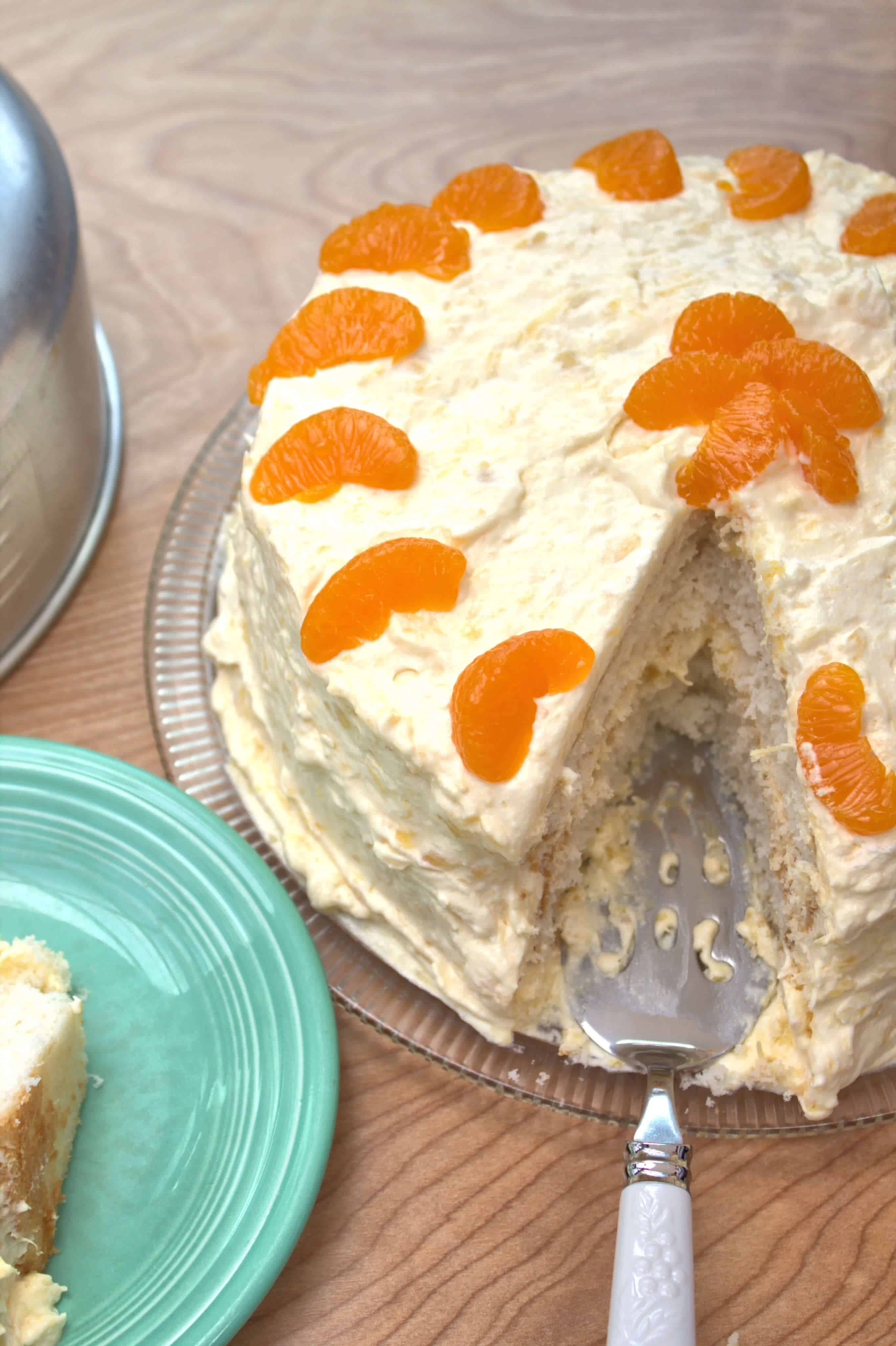 White cake with oranges with slice cut out