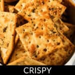 A bowl filled with ranch spicy crackers, crispy and topped with herbs and spices. Text at the bottom reads "Crispy Ranch Spicy Crackers.