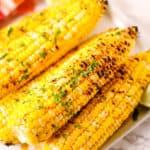 Corn on the cob with a red and white check napkin