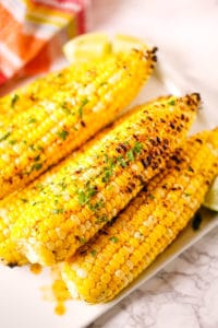 Corn on the cob with a red and white check napkin