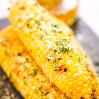 Grilled corn on black dish