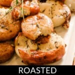 A dish of golden roasted smashed potatoes garnished with fresh herbs is presented on a white plate. The text "Roasted Smashed Potatoes" is displayed below, highlighting this flavorful delight.