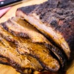 smoked brisket recipe on a wooden cutting board
