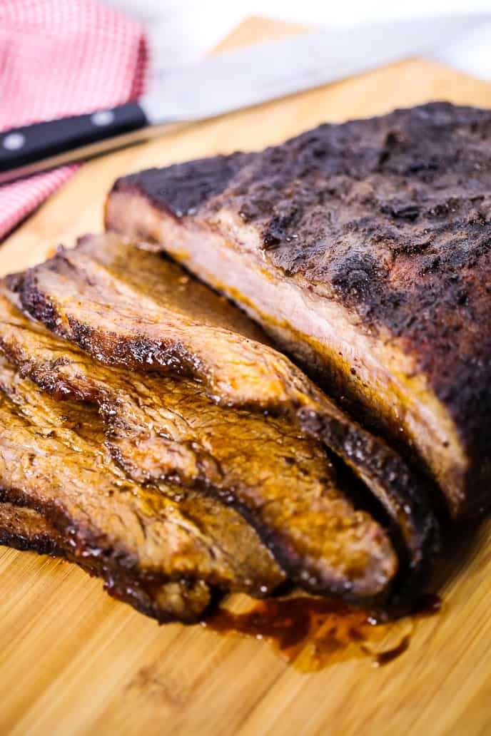 smoked brisket recipe on a wooden cutting board