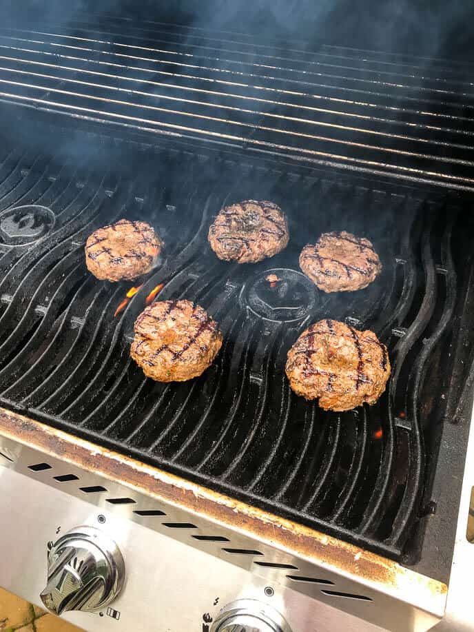 burger patties cooking on the grill