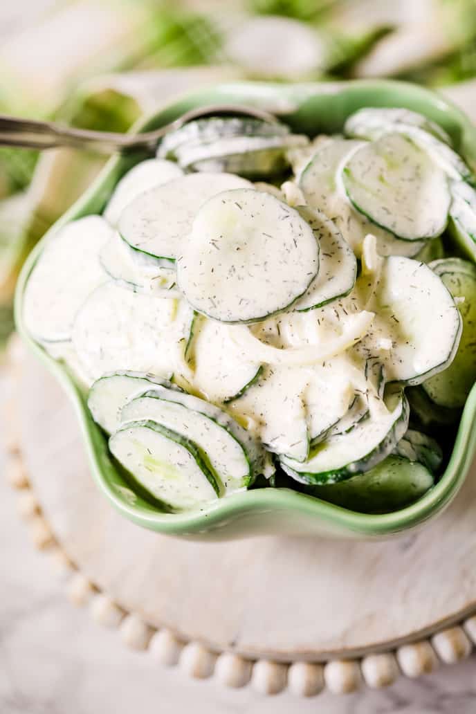 Cucumber salad on stand in green bowl