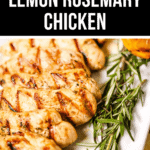 Grilled lemon rosemary chicken pieces with beautiful grill marks, garnished with fresh rosemary sprigs, served on a pristine white plate.