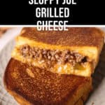 A close-up of a sloppy joe grilled cheese sandwich, oozing with savory goodness and nestled on a decorative plate. The top half is slightly lifted to reveal its hearty, flavorful filling.