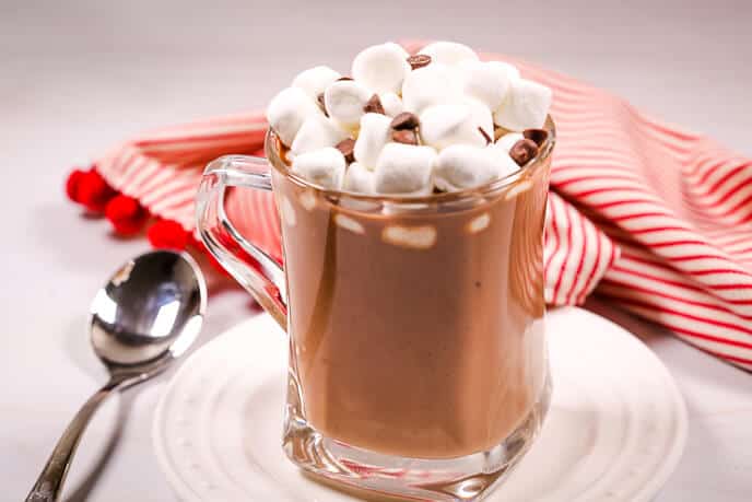 Crock pot hot chocolate with marshmallows and a striped napkin