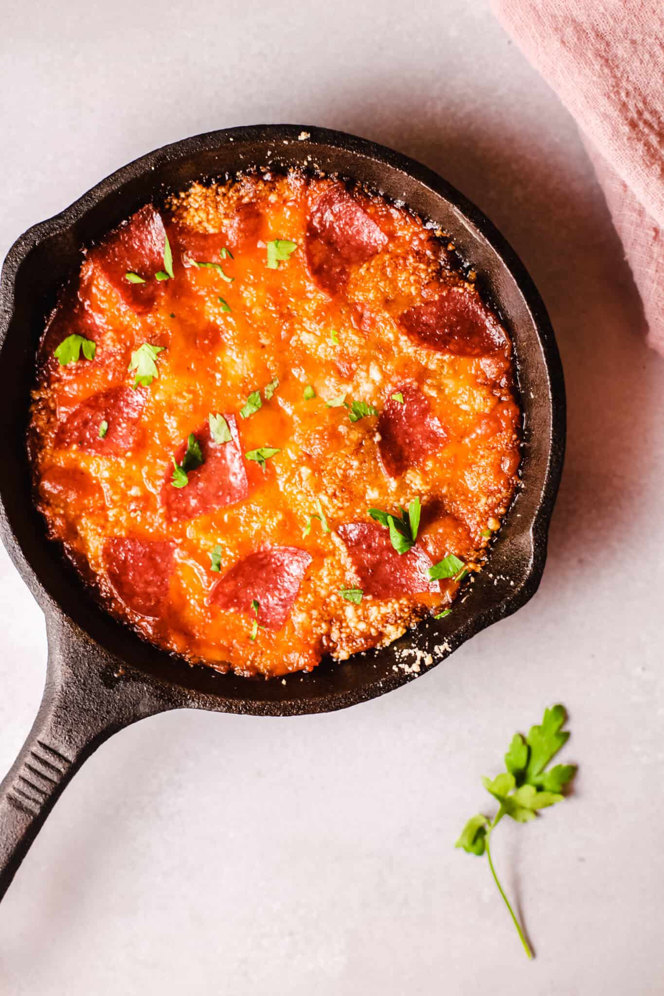 Pepperoni Pizza Dip in a skillet with parsley garnish