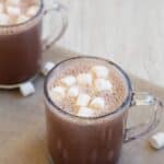 Marshmallows surrounding a cup.