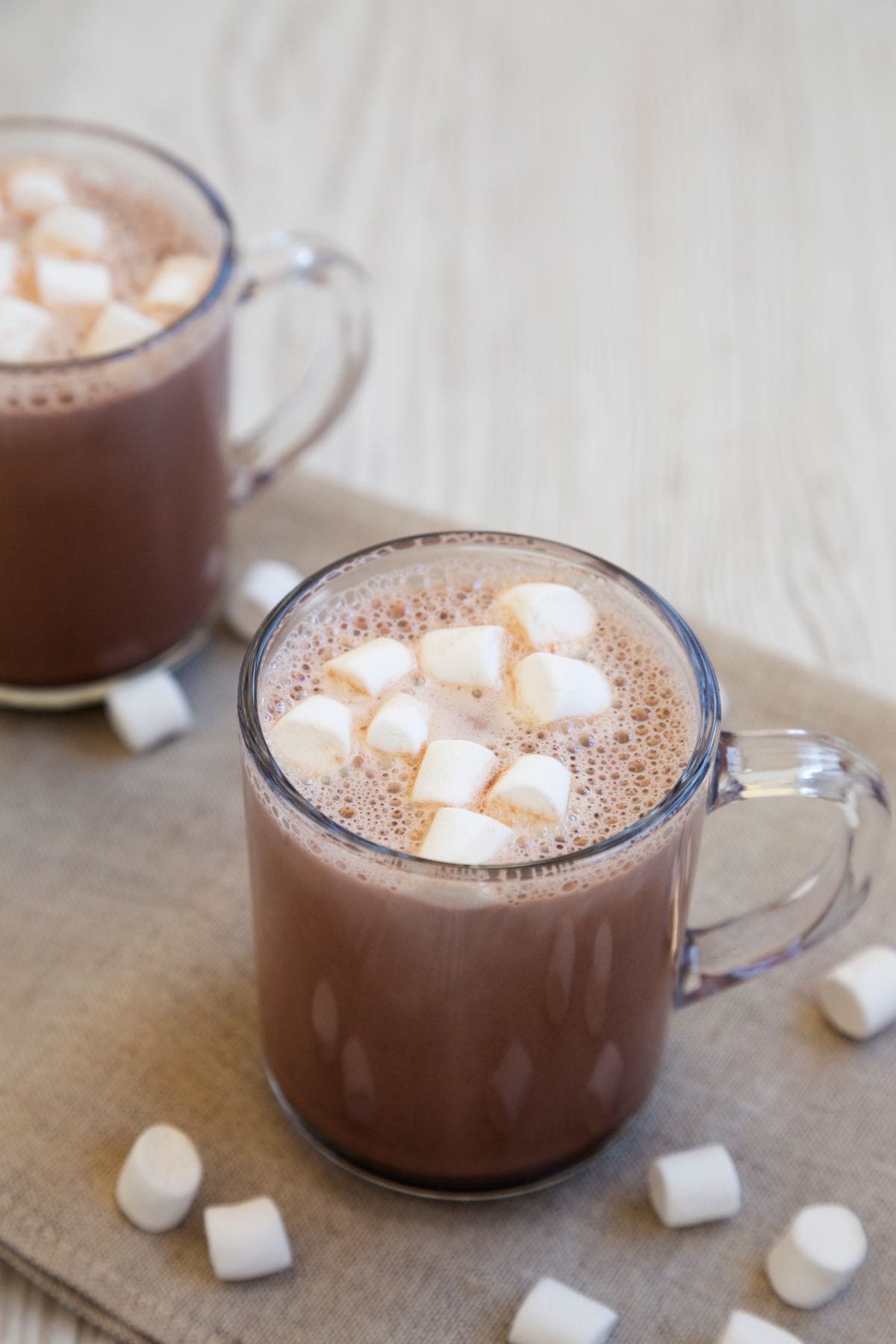 Marshmallows surrounding a cup.