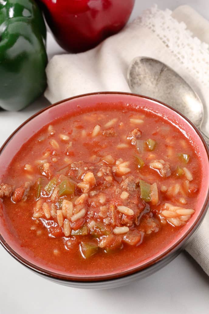 Stuffed Pepper Soup in a red bowl with a white napkin and spoon