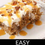 A piece of easy carrot poke cake topped with cream cheese frosting, caramel drizzle, and chopped pecans.