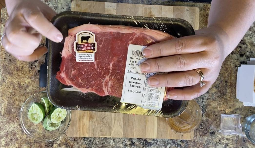certified angus strip steak in the package