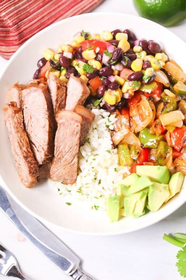 Grilled Steak Fajita Bowl with a knife and lime