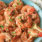A bowl of Shrimp Scampi without Wine, seasoned and garnished with herbs.