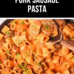 A close-up of a skillet bubbling with Italian Pork Sausage Pasta in a rich tomato-based sauce, delicately garnished with herbs. A wooden spoon scoops the savory pasta, while text above proudly announces "Italian Pork Sausage Pasta.