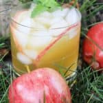 Apple Cider Mojito in a glass with 2 apples on the side