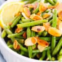 White casserole dish of Green Bean Almondine.