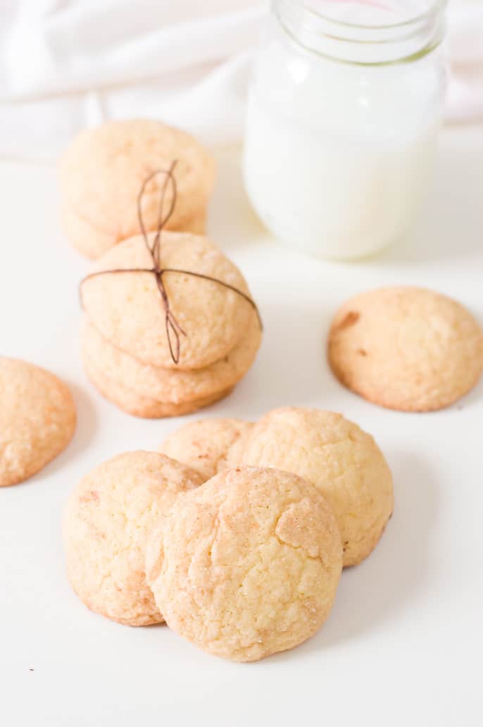 Easy snickerdoodle cookies with a glass of milk in the background