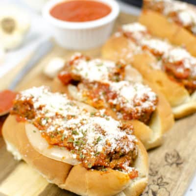 Instant Pot meatballs on a wooden board with a side of marinara in a white ramakin