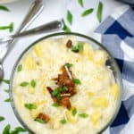 Instant Pot Potato Soup on a white table cloth with blue and white check napkin