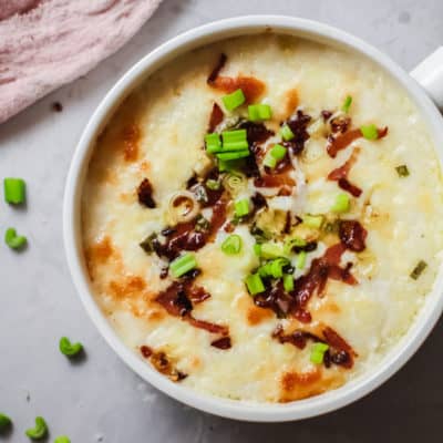 White Bowl of Mashed Potato Casserole with bacon and herb