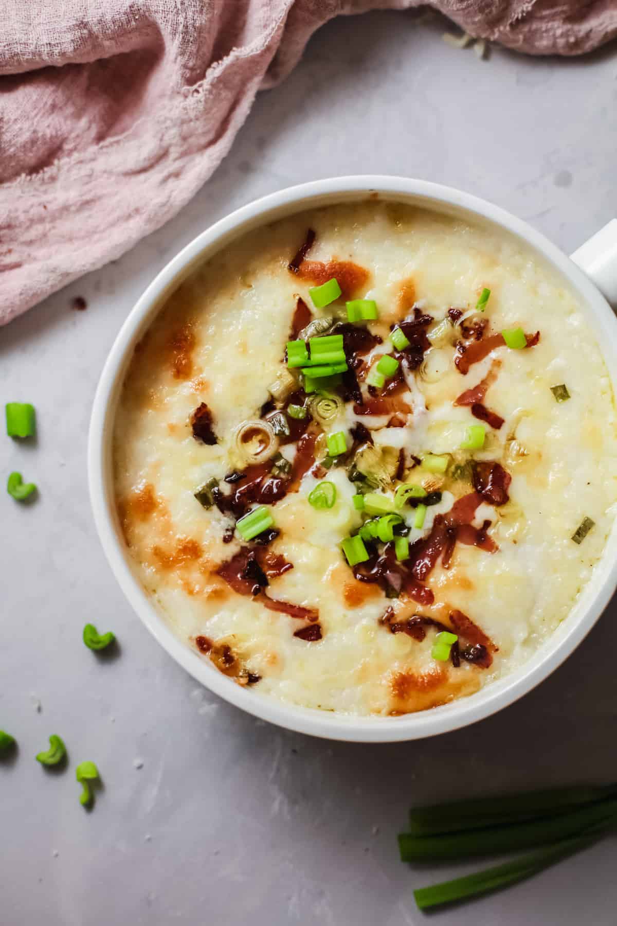 White Bowl of Mashed Potato Casserole with bacon and herb
