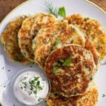 Mahed Potato Pancakes on a white plate with sour cream