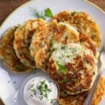 close up of mashed potato pancakes with sour cream